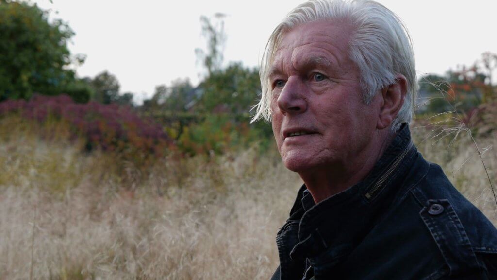 Photo of the designer Piet Oudolf with naturalistic planting in the background